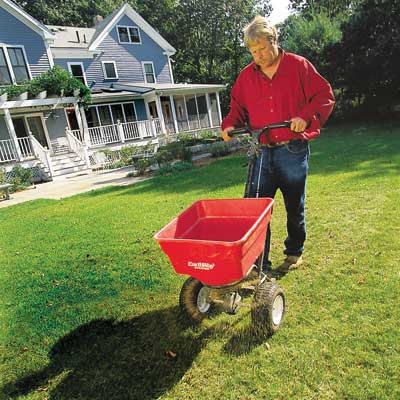 man fertilizing lawn