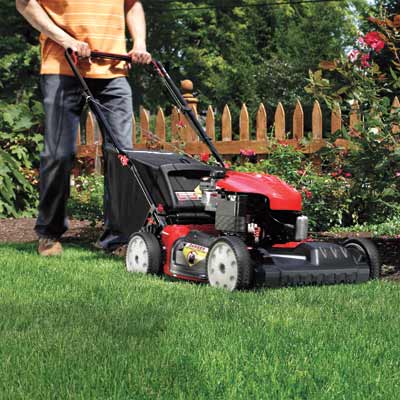 man pushing a lawn mower