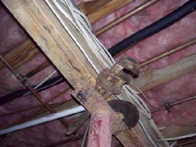 home inspection photo of wrench and weighlifter's plate used as shim block