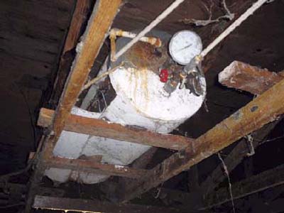 home inspection photo of water heater on its side with pressure gauge