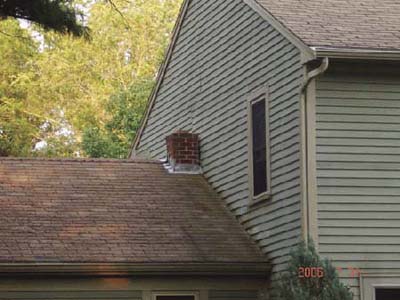 home inspection photo of chimney pushed up against house