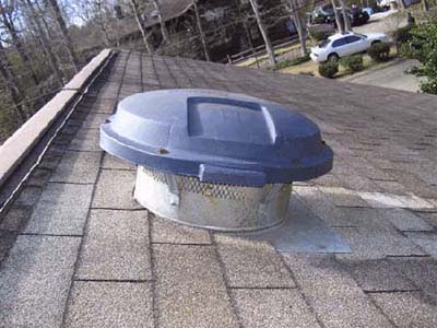 home inspection photo of Rubbermaid garbage can lid used as vent cover