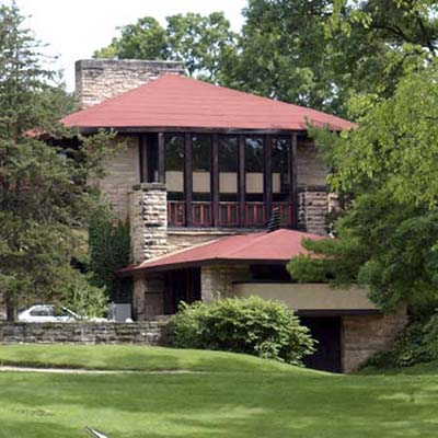 Red Taliesin House surrounded by greenery