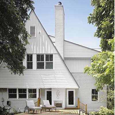 Steeply pitched gables and shed overhangs, standing-seam metal roof, rot-resistant cement-board clapboard and board-and-batten siding, energy-efficient windows, and a simple deck helped garner the house a 5-star green rating.