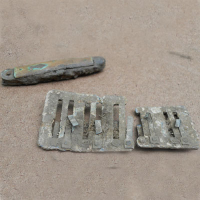 Harmonica and penknife found at the Titlow family home in Bedford, Massachusetts 