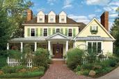 manicured house with lush landscaping and welcoming walk with curb appeal