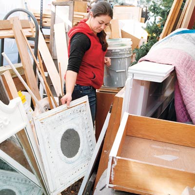 woman looking through salvage materials