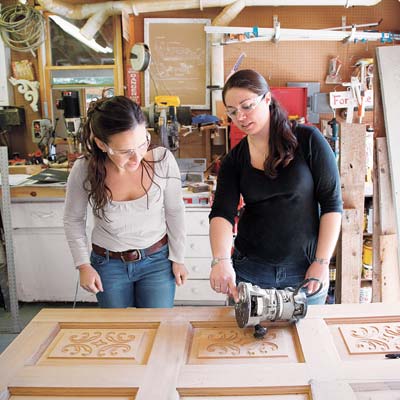 women working on salvaged furniture