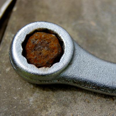socket wrench and rusted nut
