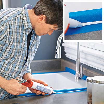 man shooting smooth caulk around kitchen sink