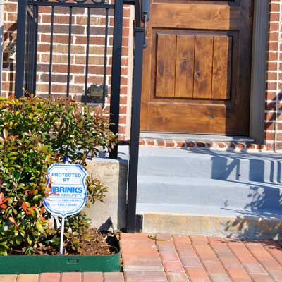 house with alarm system sign