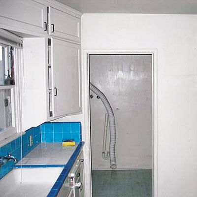 Kitchen and laundry of this bungalow before remodel