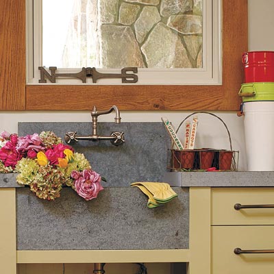 open to the outdoors potting room with rustic sink and counter
