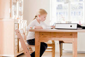 Girl doing homework at a desk table