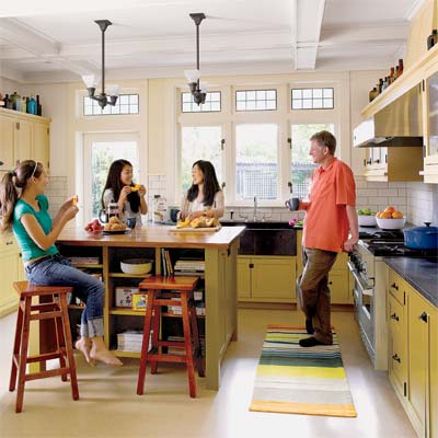 family gathered around the island in their newly remolded period look kitchen