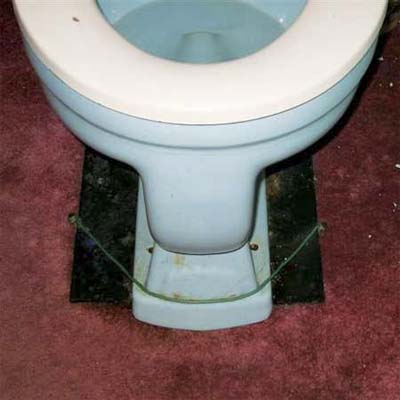 toilet tied down to make it fit where it doesn't
