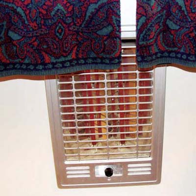 towel rack installed directly over an open heating unit