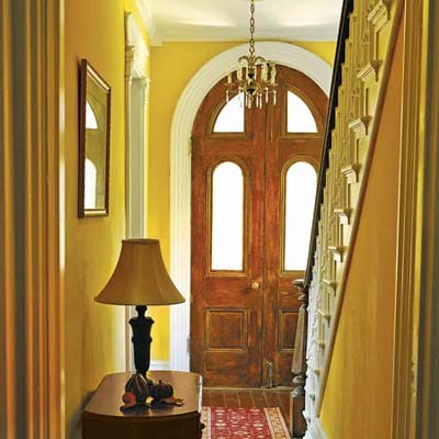 foyer with refinished entry doors and hardwood floors