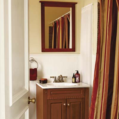 bath with wainscoting and cabinet sink and vanity with detailed moldings
