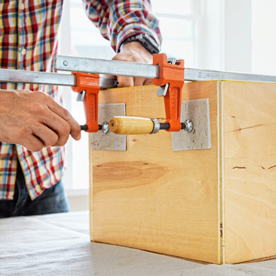 vinyl tile used to pad metal clamp from harming wood 
