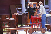 people browsing vintage furniture at flea market