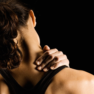 woman touching her aching shoulder