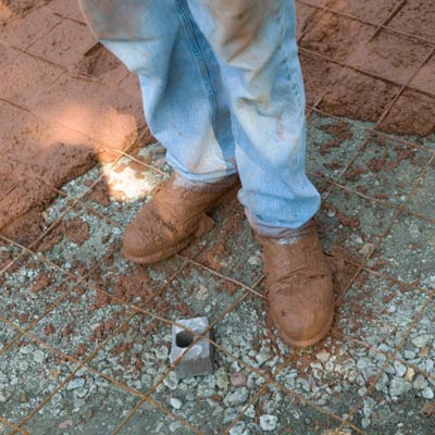 man with dirty work boots on construction site 