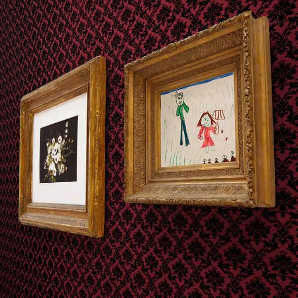 framed artwork hanging on wall