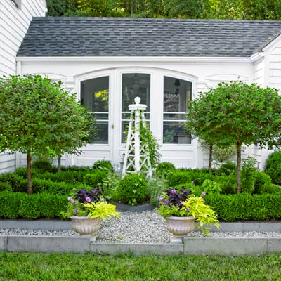garden in front colonial revival home