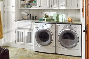 a remodeled laundry room with green towels