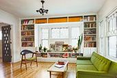 living room with white built-in bookshelves