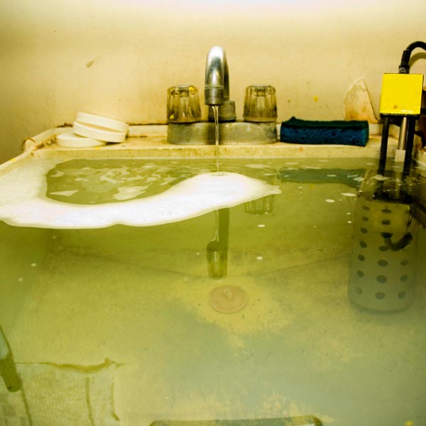 utility tub overflowing with water