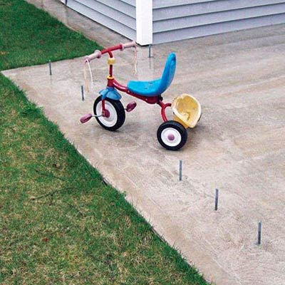 a tricycle on concrete with rebar sticking out