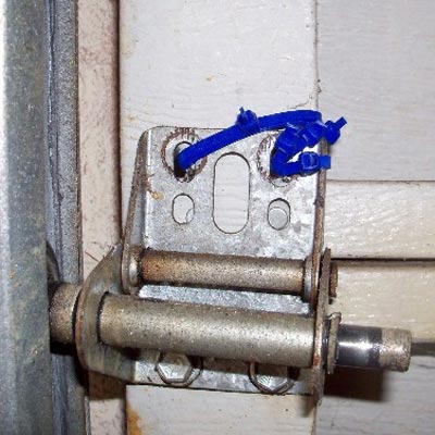 tie wraps used instead of bolts on a garage door