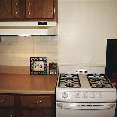 an exhaust hood over a kitchen counter but not over the stove