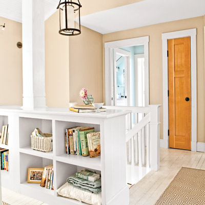 stair landing with built-in bookshelf and closets in hallway