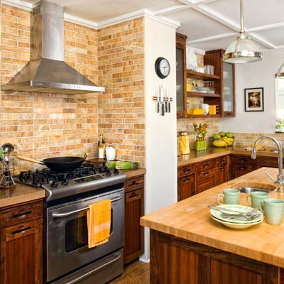 Kitchen with Marble wall tile, concrete countertops, cabinets made with exotic woods, and a butcher-block-topped island