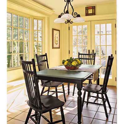 yellow dining area with table and four chairs and big windows