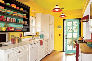 view of a kitchen in bright yellows and greens with a view to the door leading out to the patio