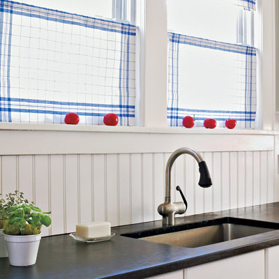 white solid backsplash behind kitchen counter and sink 