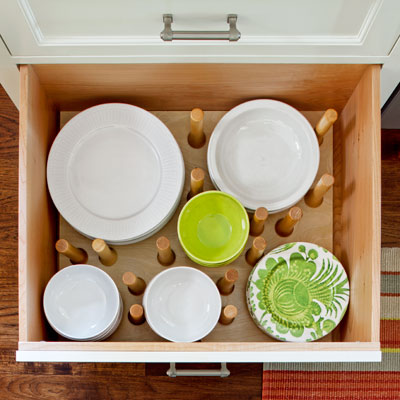 after kitchen remodel dishware drawer with adjustable pegs to hold dishes 