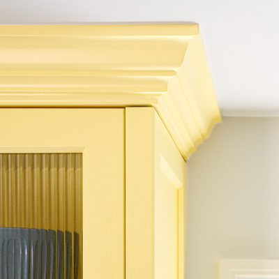 after kitchen redo yellow Shaker-style cabinets with reeded-glass fronts and crown molding
