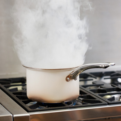 a pot with smoke on a stovtop