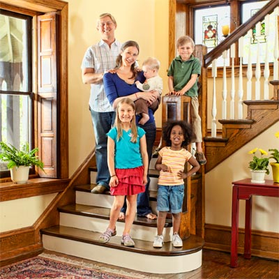 family gathered on staircase of the this old house reader remodel grand prize winning house