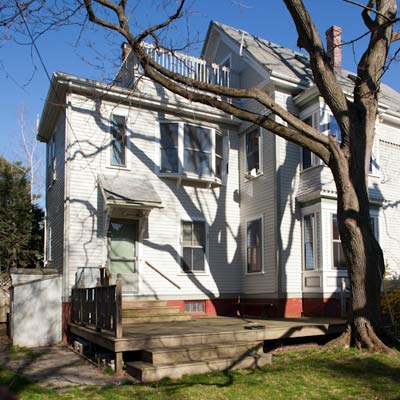 deck and backyard exterior before remodel of TOH TV project house Cambridge