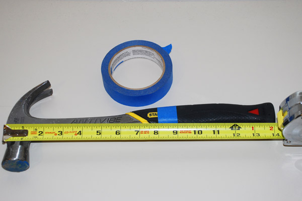 hammer marked with tape to show measurements
