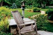 rocking chair on patio with backyard path in background