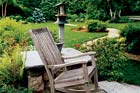 rocking chair on patio with backyard path in background