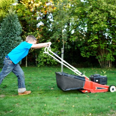 kid mowing a lawn