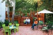 family on rebuilt backyard deck with brick patio